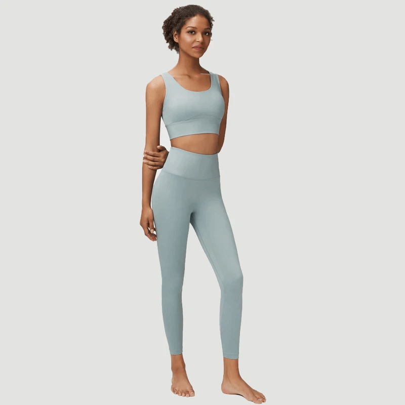Model wearing seamless yoga gear set in serene blue, featuring a sports bra and leggings for active women, perfect for yoga.